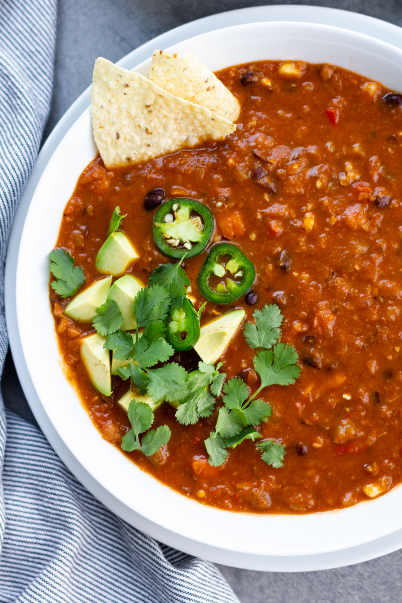 best vegetarian chili served in a bowl with avocado and jalapeños
